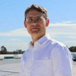 Paul Dastoor of the University of Newcastle on CHEP's rooftop covered with the new printed flexible solar cells.