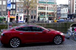 Red Tesla Model S on Amsterdam canal (Photo David van der Mark 2014)